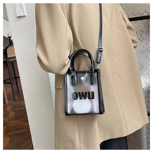 Detail of mini transparent PVC crossbody tote bag with black trim and OWU lettering