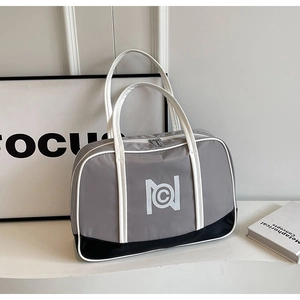 Detail of grey sports Boston handbag with black contrast base and white handle straps