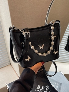Elegant black patent leather bucket bag with silver butterfly charms and beaded chain
