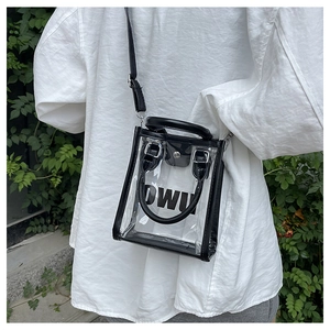 Outdoor close-up of clear PVC jelly bag with black leather trim and DWU inner pouch