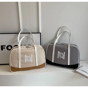 Close-up of minimalist tote bags featuring NC logo and contrast leather handles