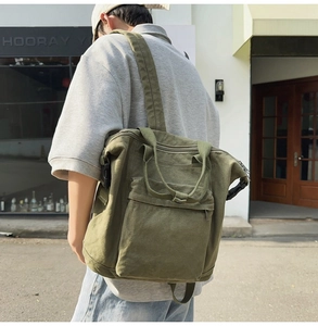 Outdoor shot of army green canvas tote bag showing side straps and large capacity