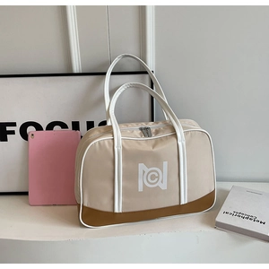 Detail of khaki travel tote bag featuring sturdy handles and durable brown reinforced base