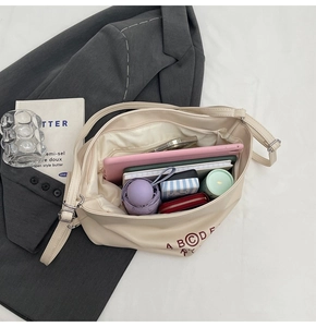 Spacious interior of beige tote bag showing tablet, umbrella and daily essentials