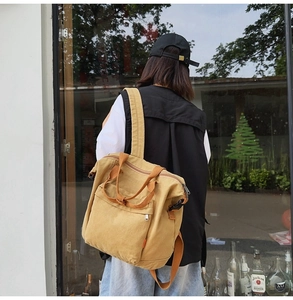 Model view showing the khaki canvas tote bag with wide straps and large capacity