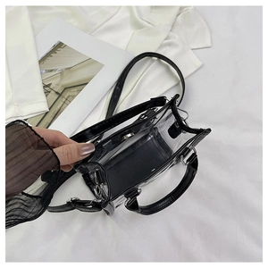 Detail showing the internal structure of the transparent PVC bag with black leather trim