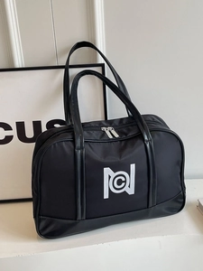 Large black nylon tote bag with white geometric logo and leather handles for travel