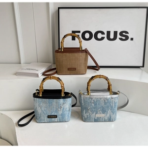 Close-up of bamboo handles and sequin texture on mini bucket bags with metal logo