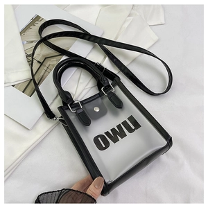 Detail of transparent black jelly bag with OWU logo, round handle, and silver snap button