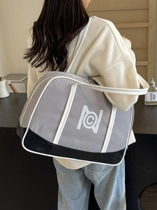 Minimalist large grey and black tote bag with white logo and straps for daily commuting