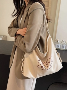 Chic cream oversized tote bag with letter print and adjustable strap in lifestyle scene