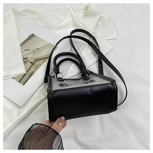 Detail shot of the reinforced black PU leather base and clear PVC panel of the mini bag