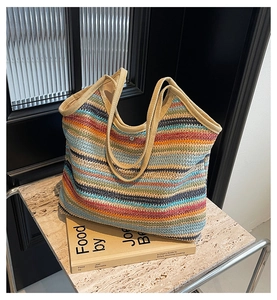 Close-up of a colorful rainbow woven tote bag showing the texture and silver magnetic clasp