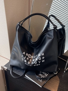 Versatile black faux leather tote backpack with letter print and adjustable strap