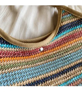 Close-up of multicolored striped woven tote bag with durable khaki webbing strap