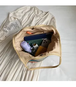 Interior view of colorful straw tote bag showing large capacity and magnetic closure