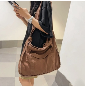 Detailed view of brown canvas tote bag featuring unique frayed edge trim and large capacity