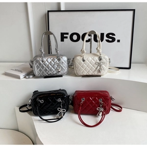 Quilted crossbody bags in four colors with diamond-studded heart charms and top handles