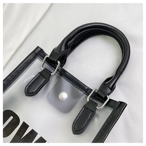 Close-up of transparent jelly tote bag with black trim and elegant pearl button closure