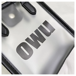 Detail of translucent frosted tote with black leather trim and bold OWU lettering
