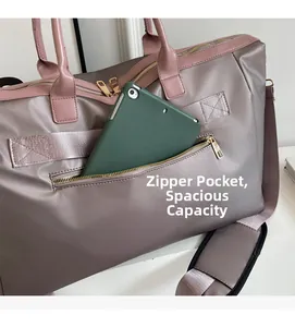 Detailed front zipper pocket of dusty pink travel bag showing iPad storage capacity