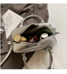 Top view of a silver quilted crossbody bag showing spacious interior for phone and cosmetics