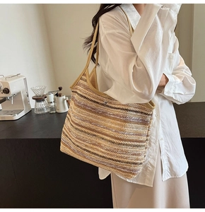 Detail of the multi-colored horizontal stripes on a large woven straw tote bag