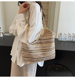 Detail of handwoven tote bag featuring beige, brown, and white horizontal stripes