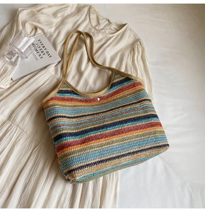 Detail of colorful striped woven tote bag with silver snap button and summer resort vibe