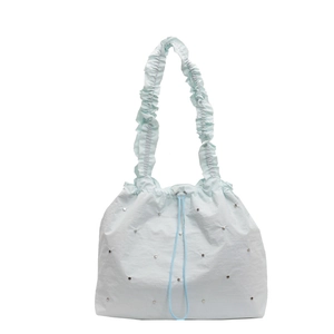 Minimalist light blue nylon handbag with ruffled shoulder straps and silver rivet accents