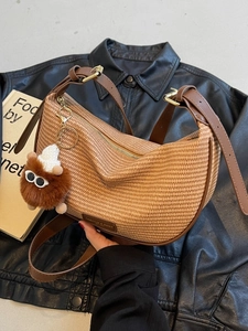 Chic khaki woven crescent crossbody bag with brown leather strap and plush charm