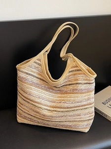 Large woven straw tote bag with earthy gradient stripes for summer beach vacations