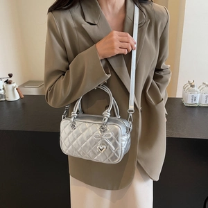 Silver quilted small square crossbody bag with bow charm and heart pendant