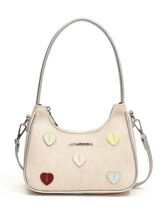 Beige canvas crescent shoulder bag with colorful heart patches and silver trim detailing