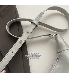 Detailed macro view of the silver PU leather bag's adjustable strap with metal buckle