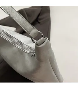 Detail of premium silver-tone hardware buckle and zipper on matte gray PU shoulder bag