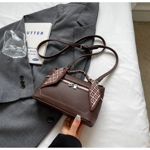 Brown lychee texture leather bag detail with silk scarf handle and silver hardware