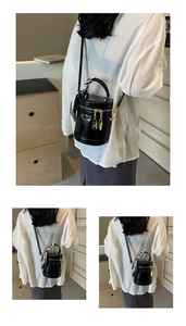 Detail of black cylindrical bucket bag featuring silk scarf handle and gold hardware
