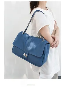 Gros plan sur le sac en jean bleu avec fermoir rotatif en métal et chaîne