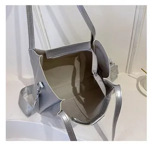 Spacious interior of metallic silver tote bag with central zipper compartment