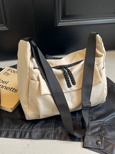 Cream canvas crossbody bag with adjustable wide strap and large capacity for daily use