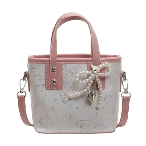 Pink and white butterfly print bucket bag with pearl bow charm and crossbody strap