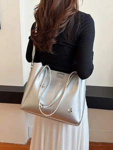 Large silver tote bag with metallic butterfly accents and textured synthetic leather