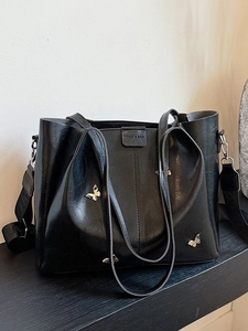 Black leather tote bag with silver butterflies and a wide detachable fashion strap