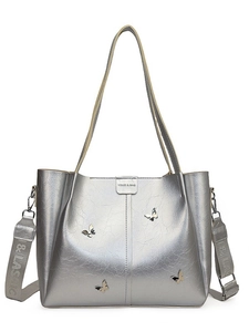 Metallic silver tote bag with 3D butterfly accents and adjustable dual shoulder straps