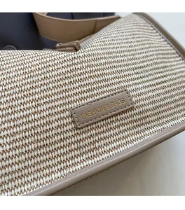 Close-up of woven fabric texture and premium leather label on the shoulder bag