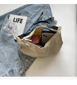 Internal view of spacious cream nylon crescent bag showing large storage capacity