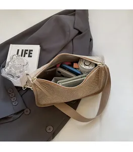 Close-up of the spacious interior of the woven bag showing phone and wallet storage