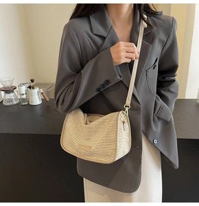 Detail of woven square bag texture with cream leather strap and fashion leather tag