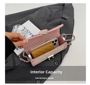 Pink cylinder chain bag internal capacity showing a smartphone and a short wallet